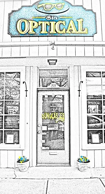 The Sia Optical storefront at 311 Main St, Falmouth, with its yellow and teal sign